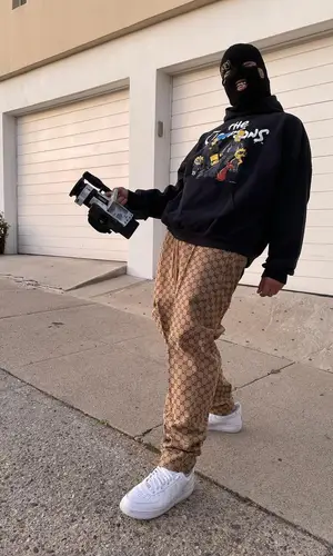 Lil Toe wearing Gucci pants