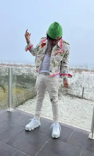 No Cap wearing Versace sneakers
