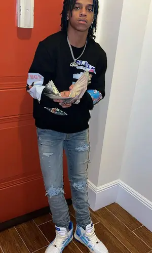 C Blu wearing Amiri jeans