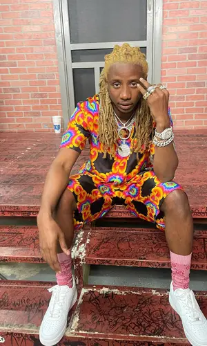 100k Track wearing Gucci shorts