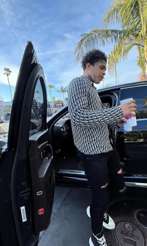 K Suave wearing Amiri jeans