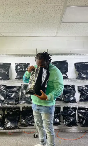 Tee Grizzley wearing Amiri sweatshirt