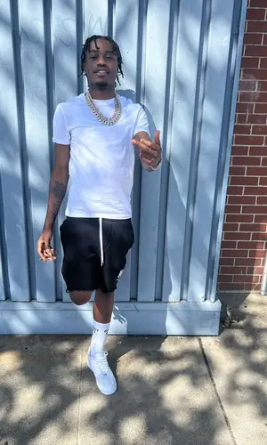 Lil Tjay wearing Amiri shorts