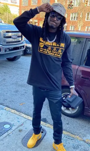 K Camp wearing All Friends Welcome shirt