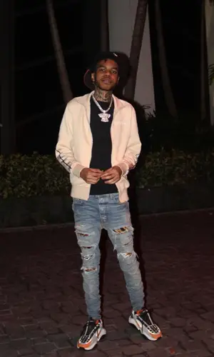 Lil Poppa wearing Palm Angels jacket