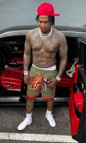 Moneybagg Yo wearing Bape shorts