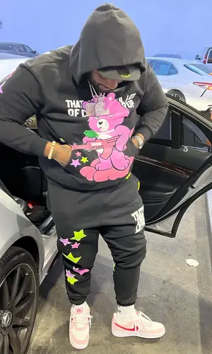 Peezy wearing Awful Lot of Cough Syrup pants