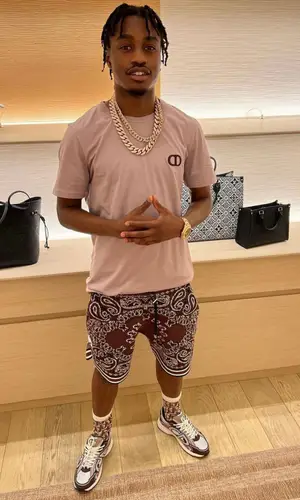 Lil Tjay wearing Amiri shorts