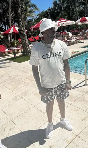 Lil Duke’s Outfit in Nike Sneakers, Celine Hat & Amiri Swimwear (2022)
