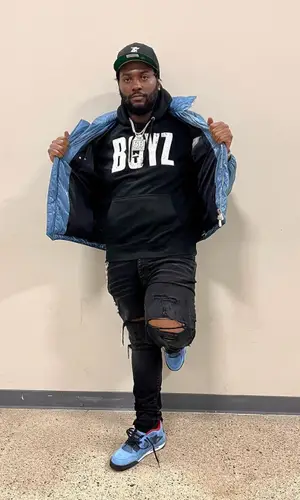 Peezy wearing Fear of God cap