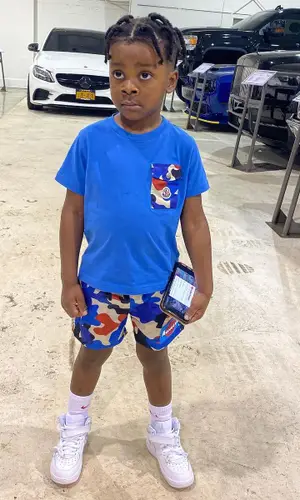 Jason Armani wearing Moncler shorts