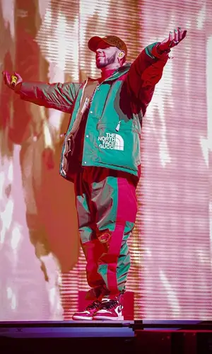 Anuel AA wearing Gucci jacket