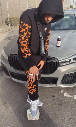 Dougie B wearing Louis Vuitton bag