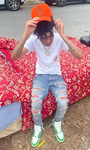 Lil Poppa wearing Amiri cap