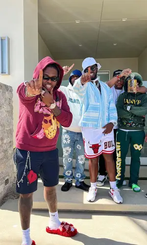 Gunna’s Outfit in Louis Vuitton Shorts, Dior Eyewear & Nike Socks (2022)