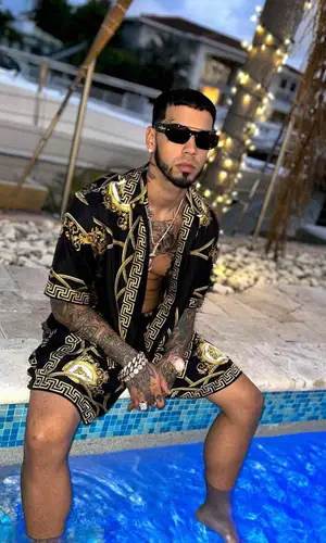 Anuel AA wearing Versace shirt