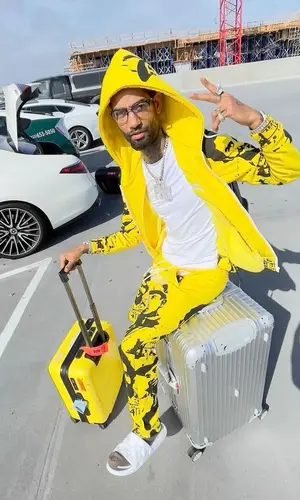 PnB Rock’s Outfit in Cough Syrup Hoodie, Louis Vuitton Backpack & Asaali (2022)