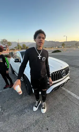 K Suave wearing Louis Vuitton belt