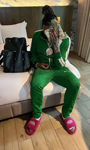 Money Man wearing Palm Angels pants