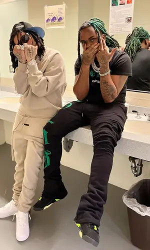Young M.A’s Outfit in Fear of God Sweatshirt, Nike Sneakers & Louis Vuitton Eyewear (2022)
