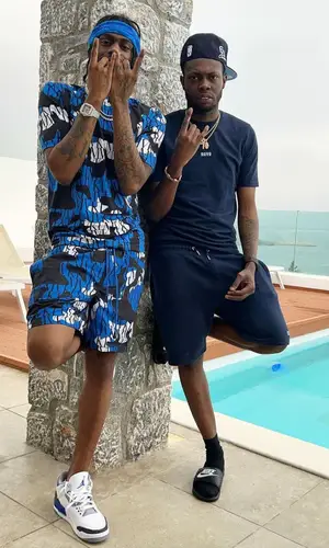 Russ Millions wearing Moving Kilos other