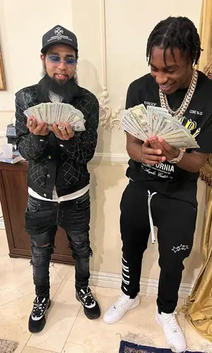 Lil Tjay wearing Amiri pants