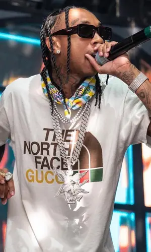 Tyga wearing 99%IS scarf
