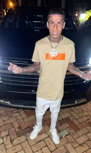Flyysoulja wearing Balmain t-shirt