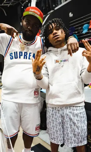 Peezy wearing Supreme cap