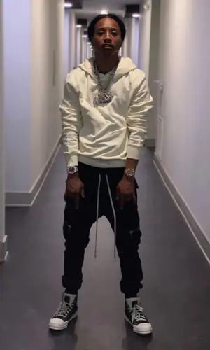 Pressa wearing Converse sneakers