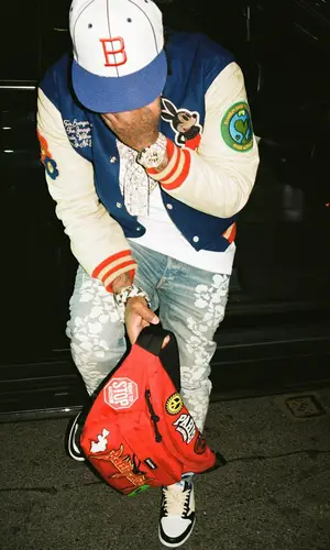 Westside Gunn’s Outfit in Stadium Goods Jacket, Amiri Jeans & Balenciaga Bag (2022)