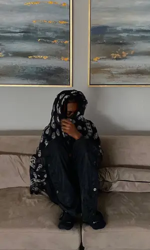Lil Benny wearing Alexander McQueen scarf