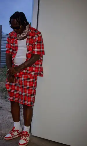 EST Gee wearing Burberry shorts