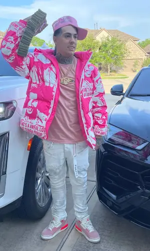 Peso Peso wearing Purple Brand jeans