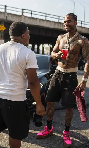 Dave East wearing Amiri shorts
