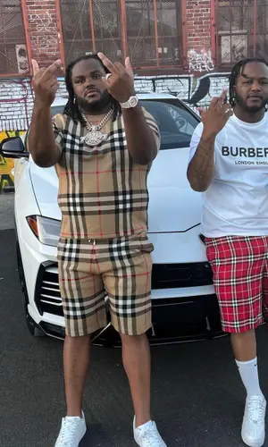 Tee Grizzley wearing Burberry shorts