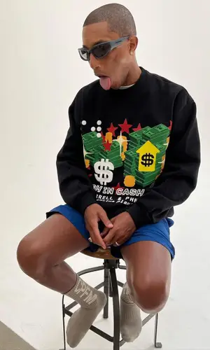 Pharrell Williams wearing Cactus Plant Flea Market sweatshirt