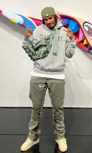 AJ Tracey wearing Takashi Murakami bag