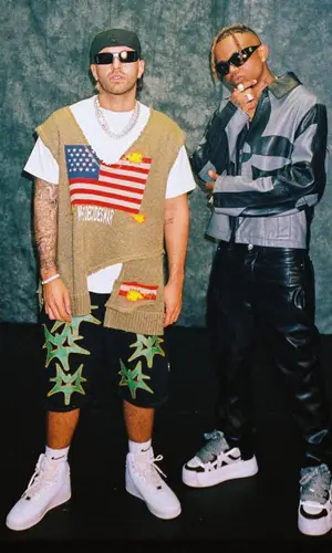 Feid wearing Who Decides War jacket
