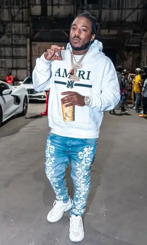 Mozzy wearing Amiri jeans