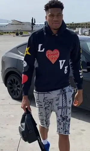 Giannis Antetokounmpo wearing Dior bag