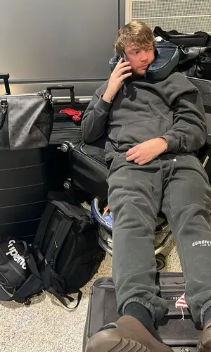 Murda Beatz’s Outfit in Fear of God Hoodie, Louis Vuitton Bag & Yeezy Sandals (2022)