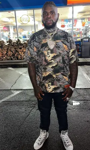 Fat Boy wearing Heron Preston t-shirt