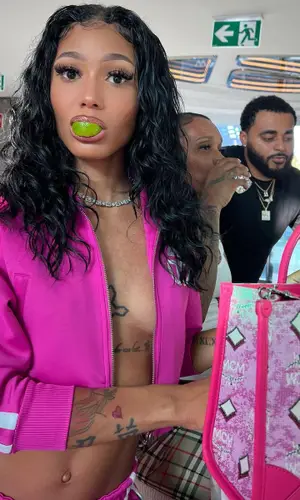 Coi Leray’s Outfit in Telfar Jacket & MCM Bag (2022)