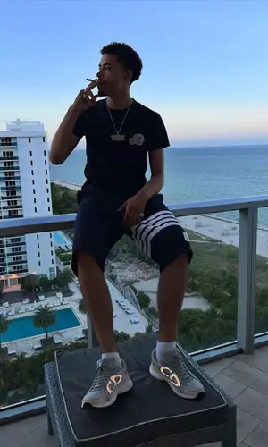 Jay Critch wearing Thom Browne shorts