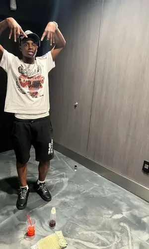 Lil Double 0 wearing Palm Angels cap