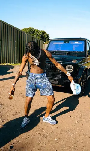 Russ Millions wearing Amiri shorts