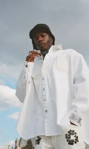 Joey Badass wearing Denim Tears jeans