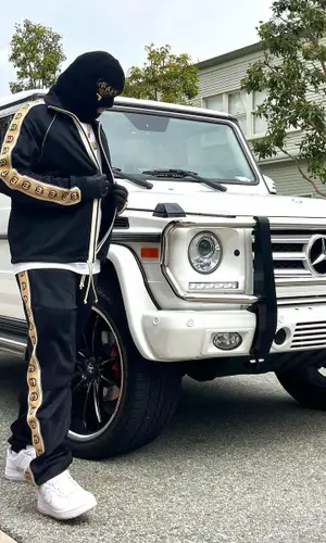 Lil Toe wearing Gucci pants