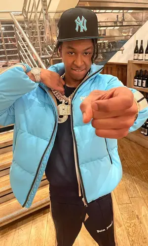 DigDat wearing Palm Angels pants